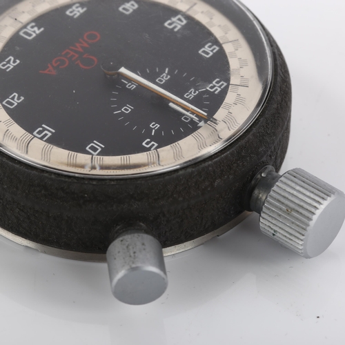 1055 - OMEGA - a stainless steel and iron split seconds stopwatch, circa 1970s, black dial with white Arabi... 