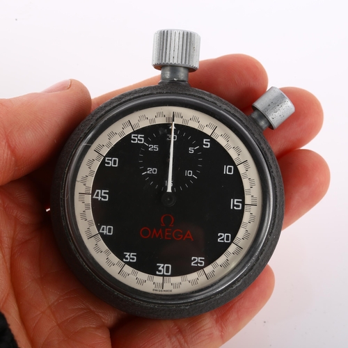 1055 - OMEGA - a stainless steel and iron split seconds stopwatch, circa 1970s, black dial with white Arabi... 