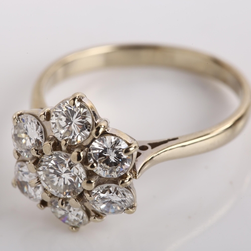 1109 - A late 20th century 18ct white gold seven stone diamond cluster flowerhead ring, set with modern rou... 