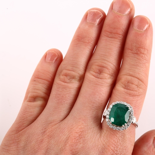 1122 - A modern 18ct white gold emerald and diamond cluster ring, set with 6.5ct oval cushion-cut emerald a... 