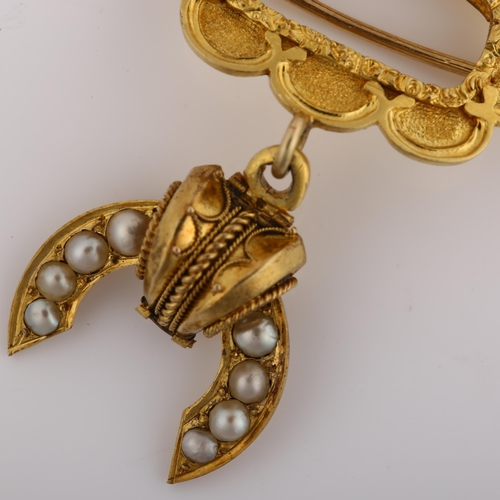 1129 - A Victorian Etruscan style split pearl memorial drop brooch, with a central vacant panel within flor... 