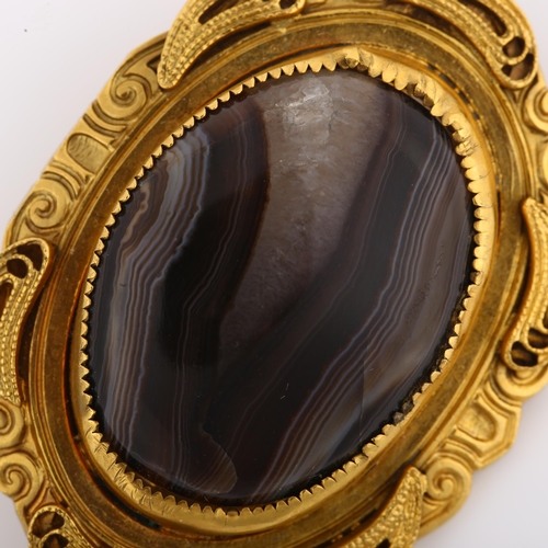 1131 - A Victorian Etruscan style banded agate brooch, unmarked yellow metal settings with wirework decorat... 