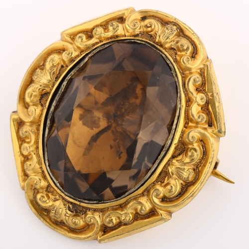 1132 - A Victorian foil-backed smoky quartz brooch, unmarked yellow metal closed-back settings with relief ... 