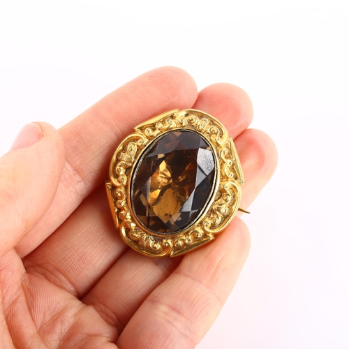 1132 - A Victorian foil-backed smoky quartz brooch, unmarked yellow metal closed-back settings with relief ... 