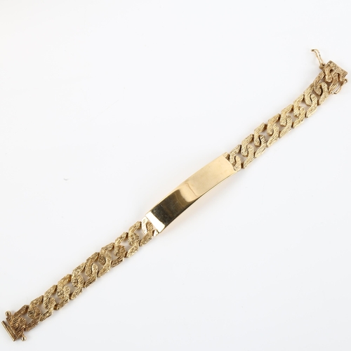 1143 - A late 20th century 9ct gold identity bracelet, with textured flat curb links, maker's marks R Co, h... 