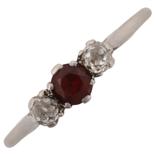 1172 - A three stone ruby and diamond ring, unmarked white gold settings test as 18ct, total diamond conten... 