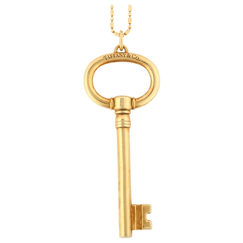 1173 - TIFFANY & CO - a large 18ct gold key pendant necklace, on 18ct fancy link chain, key length 62.3mm, ... 