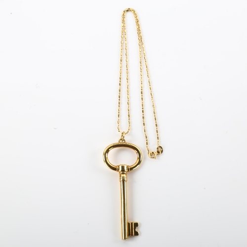 1173 - TIFFANY & CO - a large 18ct gold key pendant necklace, on 18ct fancy link chain, key length 62.3mm, ... 