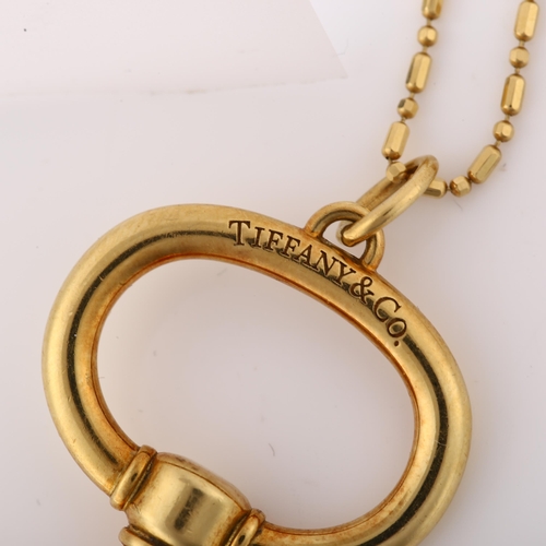 1173 - TIFFANY & CO - a large 18ct gold key pendant necklace, on 18ct fancy link chain, key length 62.3mm, ... 