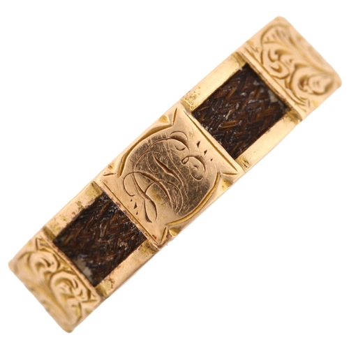 1174 - A Victorian 15ct gold mourning band ring, with alternating woven hair and engraved foliate panels wi... 