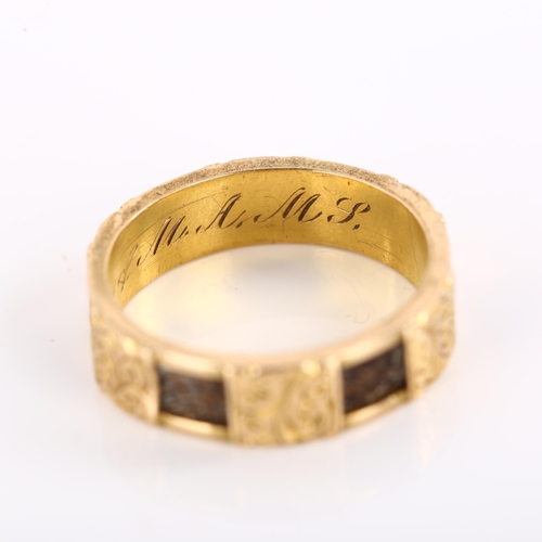 1174 - A Victorian 15ct gold mourning band ring, with alternating woven hair and engraved foliate panels wi... 