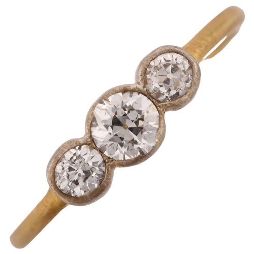 1190 - A three stone diamond ring, unmarked gold settings with old European-cut diamonds, total diamond con... 