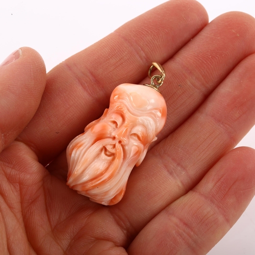 1204 - A Chinese coral Shoulau God head pendant, unmarked gold mount, pendant height 45.5mm, 9.6g