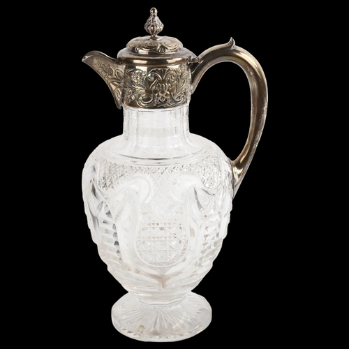 1516 - An Edwardian silver-mounted glass Claret jug, with relief embossed decoration and acanthus leaf fini... 