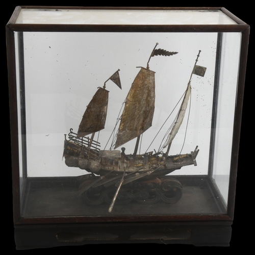 1520 - A Chinese white metal model junk boat, in glazed display case, W26cm, H27cm, D13cm