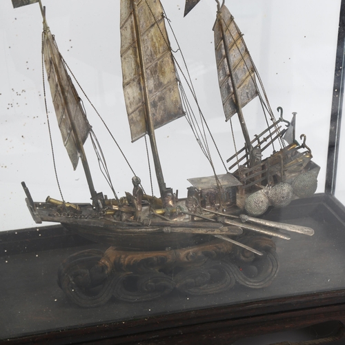 1520 - A Chinese white metal model junk boat, in glazed display case, W26cm, H27cm, D13cm