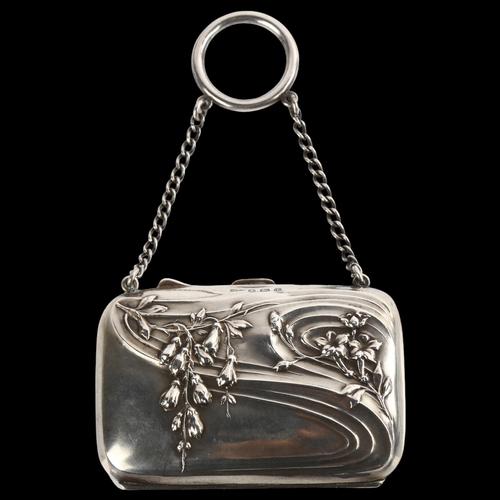 1522 - An Art Nouveau George V lady's silver purse, with relief embossed floral decoration and ring suspend... 