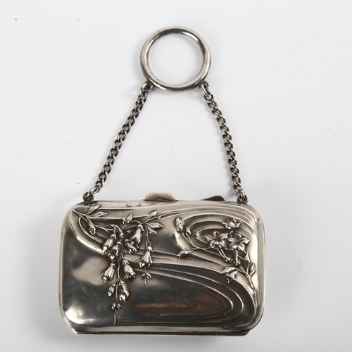 1522 - An Art Nouveau George V lady's silver purse, with relief embossed floral decoration and ring suspend... 