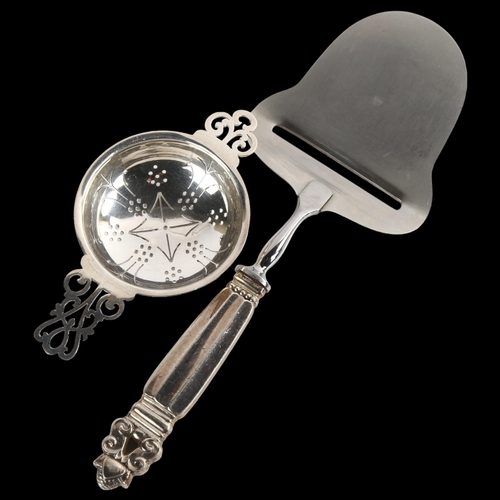 1531 - A Georg Jensen Danish silver Acorn/Konge pattern cheese slicer, and a silver tea strainer, length 11... 