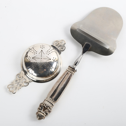 1531 - A Georg Jensen Danish silver Acorn/Konge pattern cheese slicer, and a silver tea strainer, length 11... 