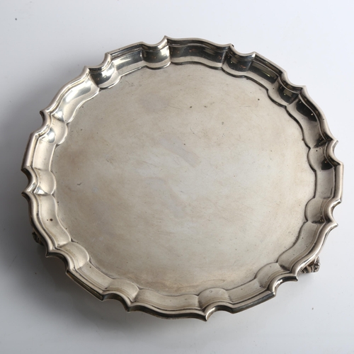 1535 - A Victorian circular silver salver, with scalloped rim and scrolled acanthus leaf feet, possibly by ... 