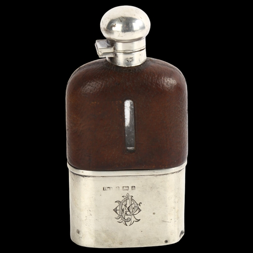 1538 - A leather-mounted glass hip flask, with silver plated cap and silver beaker, height 15cm