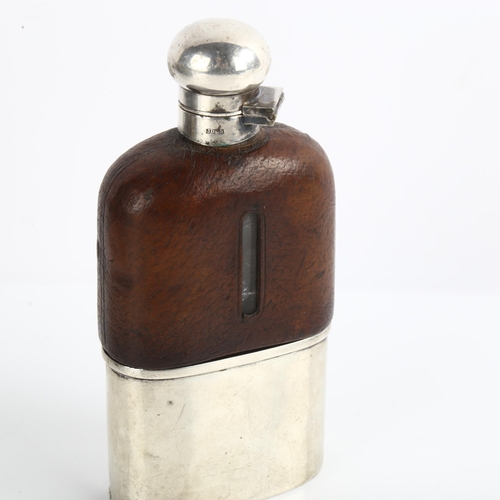 1538 - A leather-mounted glass hip flask, with silver plated cap and silver beaker, height 15cm