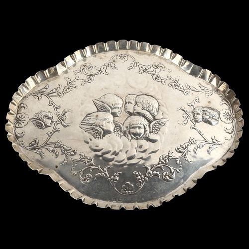 1541 - An Edwardian silver dressing table tray, oval lobed form with crimped rim and relief embossed cherub... 