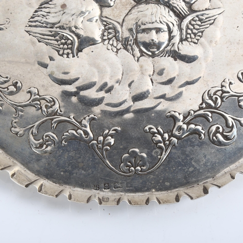 1541 - An Edwardian silver dressing table tray, oval lobed form with crimped rim and relief embossed cherub... 