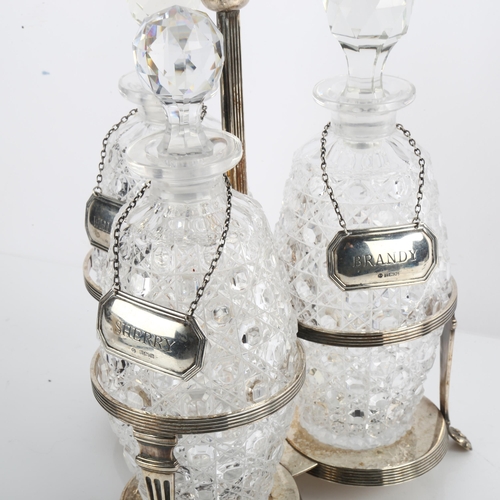 1551 - A silver plated 3-bottle tantalus, with ovoid decanters and silver labels, overall height 32cm