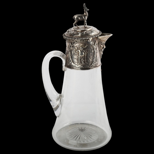 1554 - A Victorian silver-mounted glass Claret jug, with relief embossed decoration, stag finial and later ... 