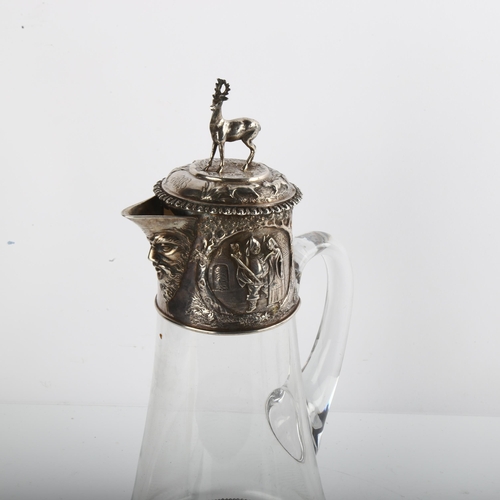 1554 - A Victorian silver-mounted glass Claret jug, with relief embossed decoration, stag finial and later ... 