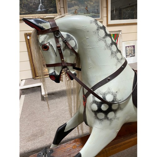 57 - An early 20th Century dappled grey Rocking Horse in the manner of F.H.Ayres, London, with studded le... 