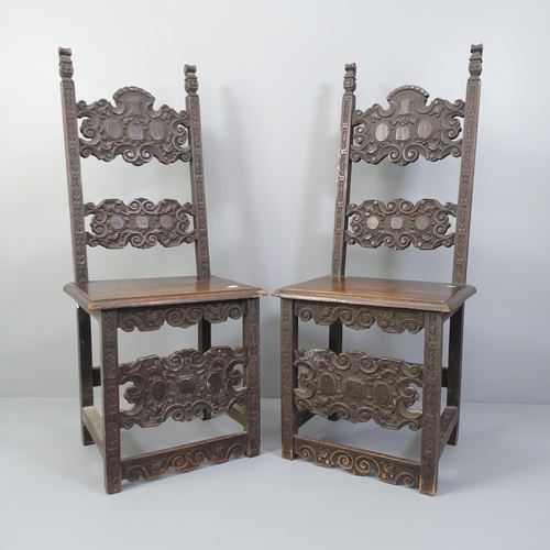 2002 - A pair of carved oak renaissance style hall chairs.