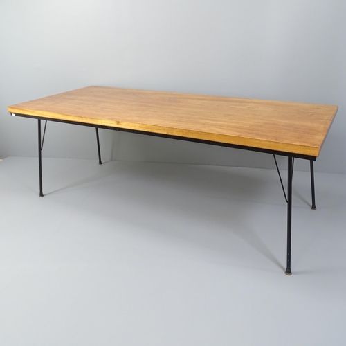 2003 - A mid-century teak dining table with ebonised frieze and iron rod legs. 198x71x84cm