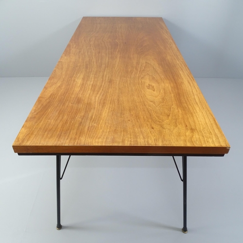 2003 - A mid-century teak dining table with ebonised frieze and iron rod legs. 198x71x84cm