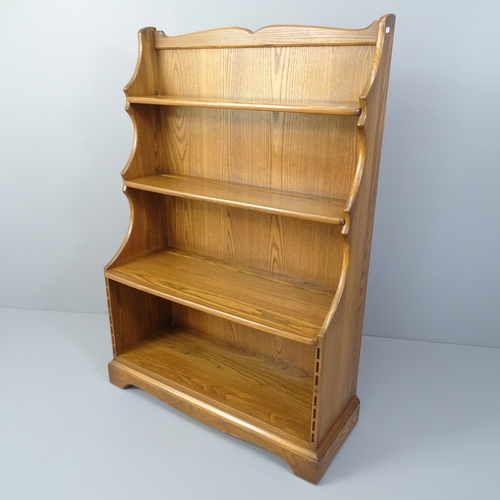 2004 - An Ercol mid-century elm waterfall open bookcase, with maker's label. 89x128x33cm.