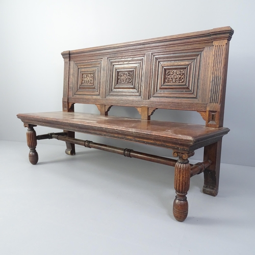 2008 - An antique carved and panelled oak hall seat. 145x91x50cm