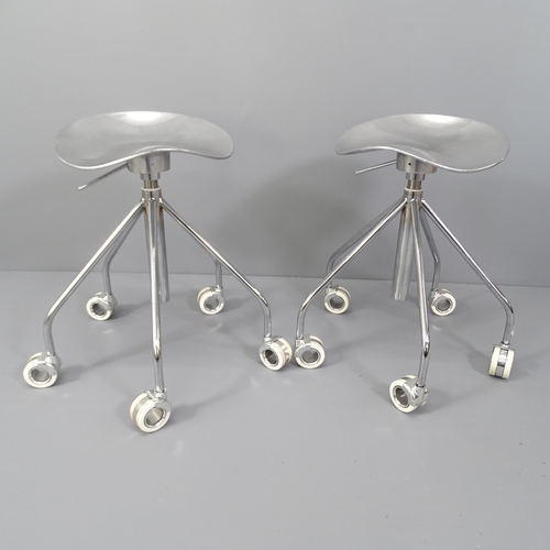 2011 - A pair of polished cast aluminium stools with gas height adjust on white hollow wheels.