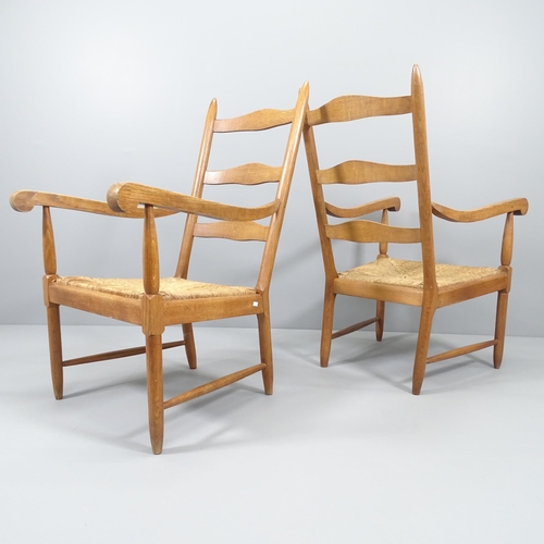 2024 - A pair of mid-century ladderback lounge chairs, in oak with rush seats.