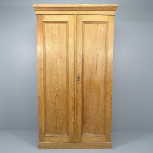 2025 - An antique pine two-door compactum wardrobe, with fitted interior. 116x206x57cm.