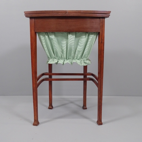 2027 - An Edwardian Arts & Crafts work table in the manner of Liberty, the top opening to reveal a fitted i... 