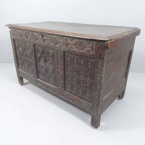 2031 - An antique carved oak coffer, raised on stile legs. 122x74x58cm.