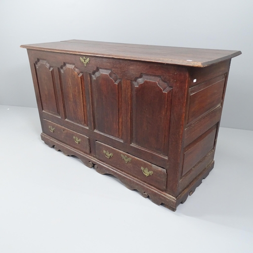 2037 - An antique panelled oak mule chest, with brass mounts. 152x88x60cm