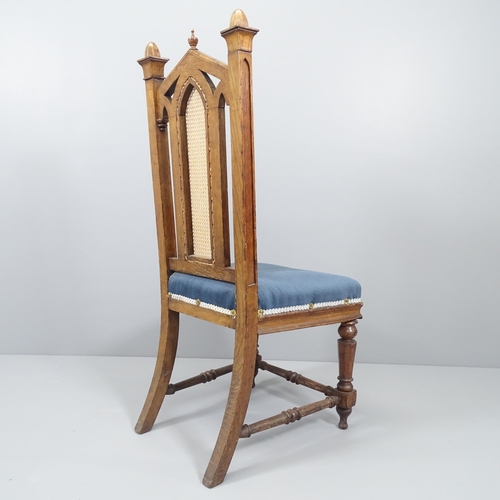 2041 - WITHDRAWN - An antique Gothic oak and upholstered Pugin style chair, with cane panelled back. Origin... 