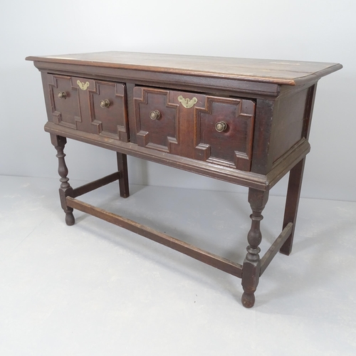 2517 - A 1920s oak sideboard with two fitted drawers and applied carved decoration. 130x92x56cm.