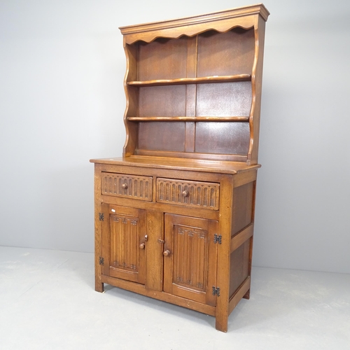 2524 - An early 20th century two section oak dresser, with linenfold carved decoration. 97x174x46cm.