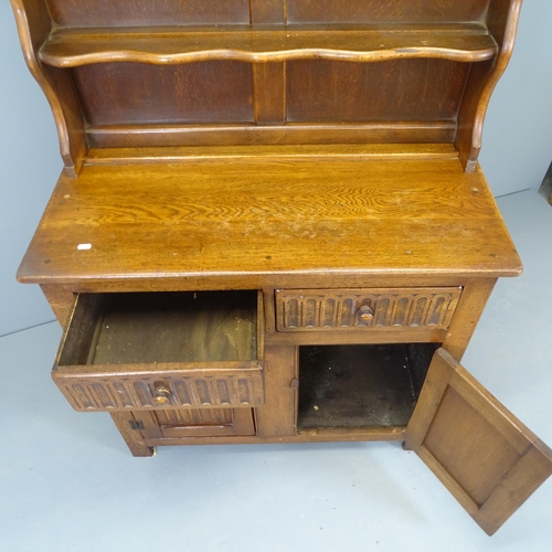 2524 - An early 20th century two section oak dresser, with linenfold carved decoration. 97x174x46cm.