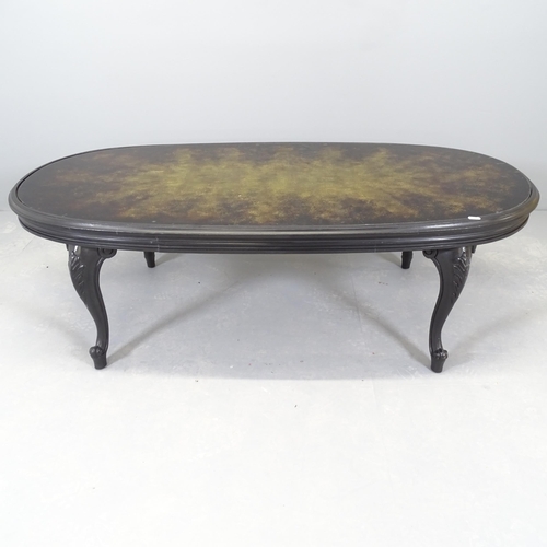 2537 - A modern ebonised oval coffee table, with inset glass top. 137x45x64cm.