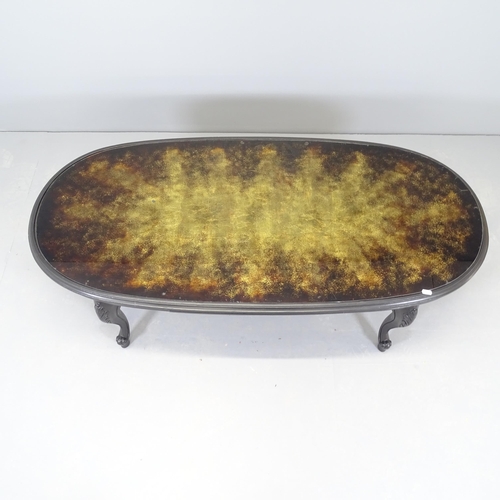 2537 - A modern ebonised oval coffee table, with inset glass top. 137x45x64cm.